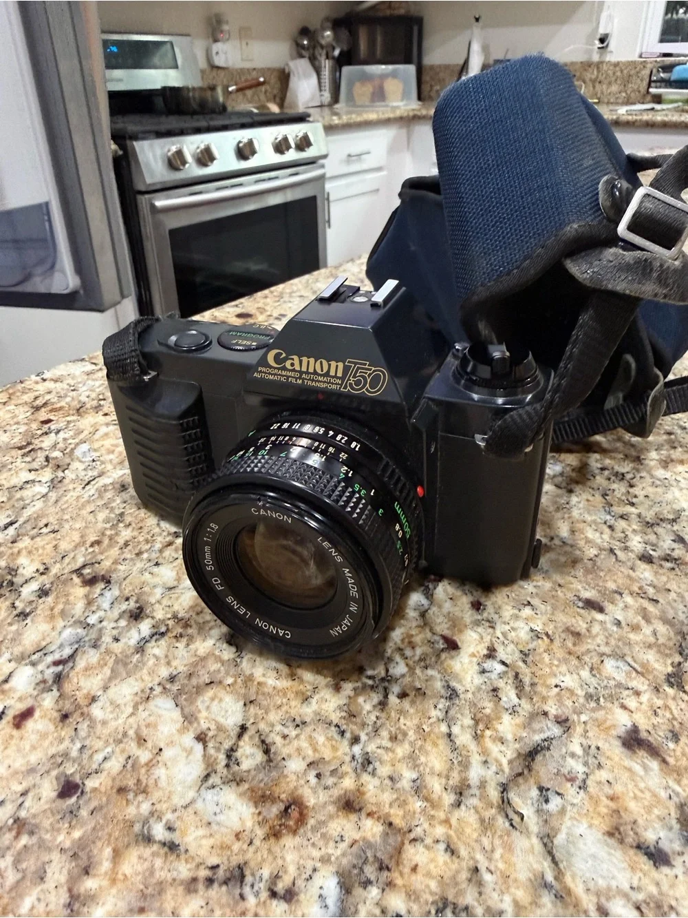Canon T50 Black 35mm SLR Camera with Attached Lens